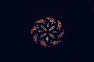 Stained glass rose window of a Christian church