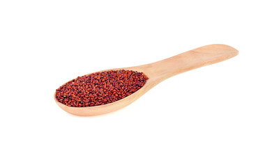 red quinoa seeds in wooden spoon isolated on white background