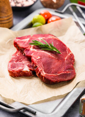 Fresh beef steak on a concrete background