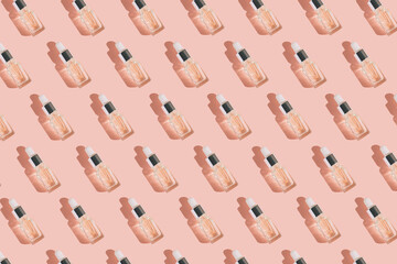 Creative pattern made of transparent bottle with pipette of hyaluronic acid serum with collagen or essential oil on pastel background with shadow. Natural treatment concept.