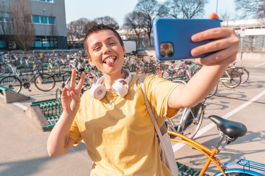 Woman takes a selfie with cellphone in a bicycle parking