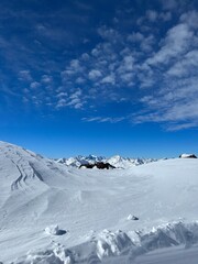 Fototapeta na wymiar The sun at the Elbrus ski resort. White snow and mountain peaks