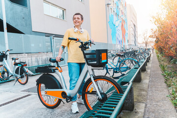 Fototapeta premium Woman takes a rented bicycle in a bicycle parking