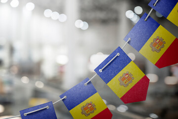 A garland of Andorra national flags on an abstract blurred background