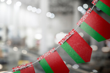 A garland of Belarus national flags on an abstract blurred background