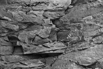 Grungy cragged bumpy pitted cavity stone facade, split layer gap.Ruined cracked shattered worn rough hiking canyon.Old ragged grunge steep marble cliff. Grand vintage crannied damaged impressive gorge