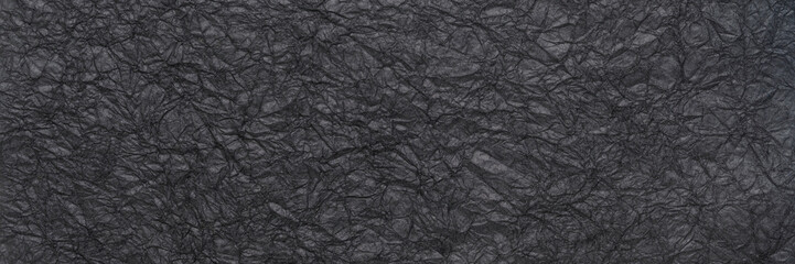 background and texture of black wrinkled art paper, panoramic web banner