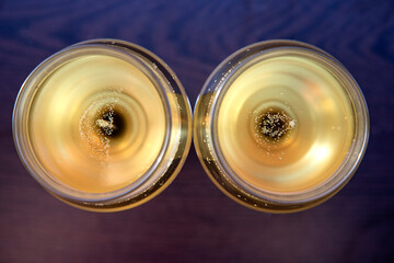 Two glasses with champagne with small babbles gold color 