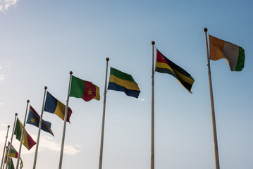 Flags of different shades representing various countries aligned in the air in downtown Ikeja,...