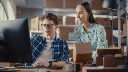 Warehouse Inventory Manager and Worker Using Desktop Computer, Preparing a Parcel for Shipping. Small Business Owners Working in Storeroom, Preparing Online Orders for Clients. Slow Motion