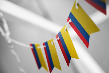 A garland of Colombia national flags on an abstract blurred background