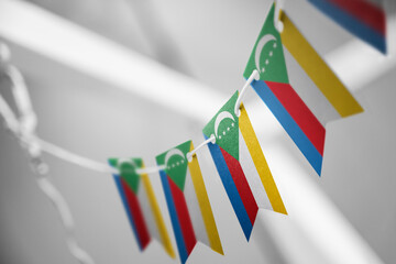 A garland of Comoros national flags on an abstract blurred background