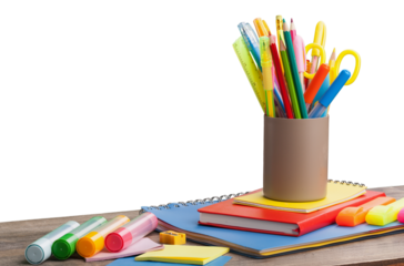 Colored school supplies on wooden table