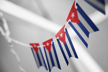 A garland of Cuba national flags on an abstract blurred background