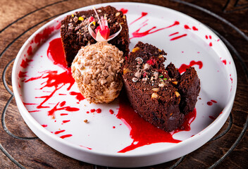 Chocolate Brownie cake with Vanilla Ice Cream on black plate