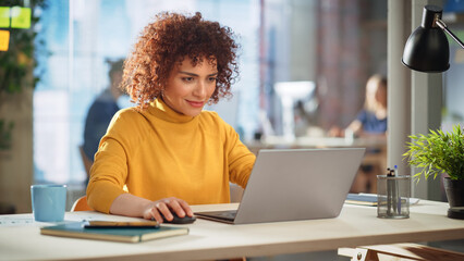 Creative Multiethnic Female Working on Laptop Computer in a Company Office. Happy Excited Project...