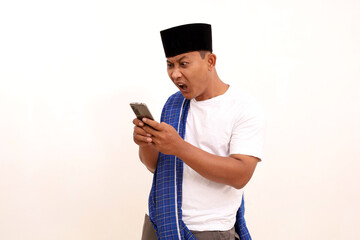 Shocked asian man while looking at his cellular phone. Isolated on white background