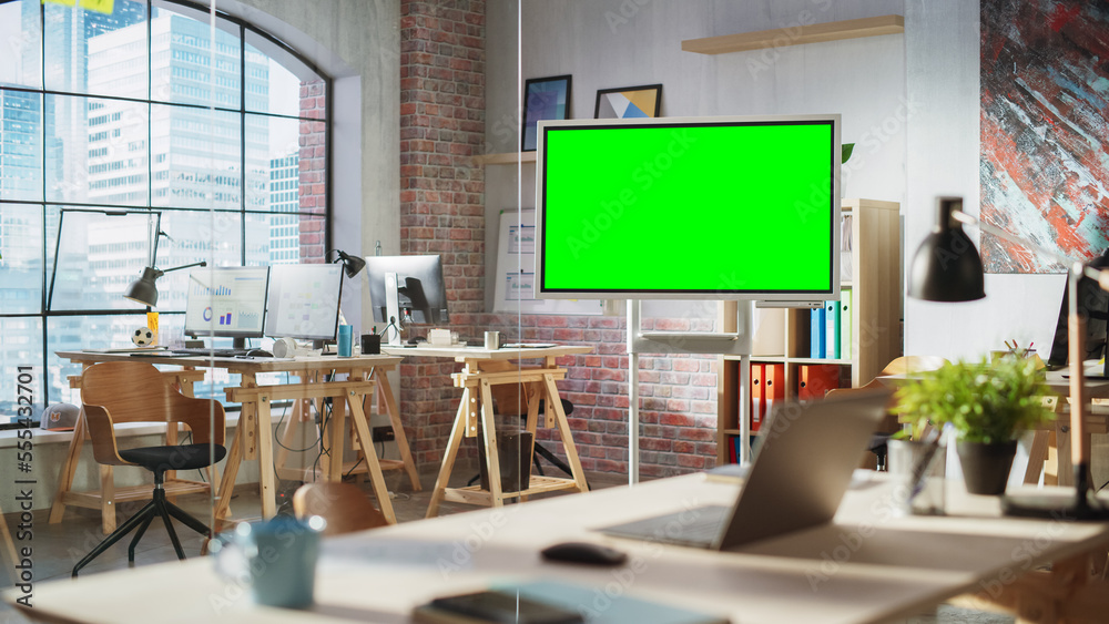 Poster Empty Conference Room for Team Meetings in Modern Creative Agency with Art on Walls and Desks with Computers. Office Space with Digital Green Screen Mock Up Chroma Key Monitor for Presentations.
