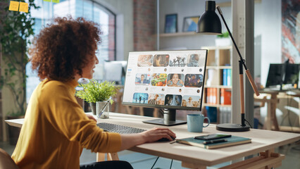 Middle Eastern Female Working in Creative Agency, Looking Through Social Media Trends for Marketing. Successful Specialist Using Computer with Video Streaming Platform on Screen Display
