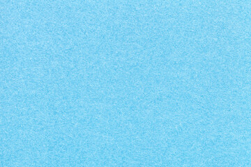 Texture of old craft light blue paper background, closeup. Structure of a vintage cerulean cardboard.