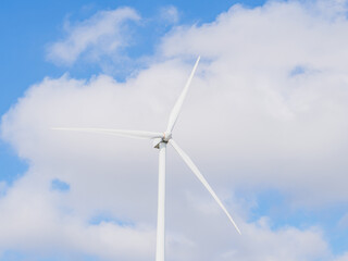 Close-up of Wind electric generator. Wind generators stand in agricultural fields with Powerful wind turbine farms for pure energy production on the background.	