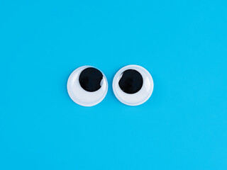 funny  googly eyes cute  Isolated on bright light blue  background copy space logo