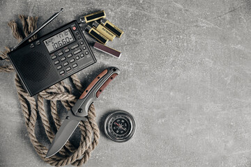 Tactical folding knife for survival, radio, rope, matches,batteries and compass, survival kit in difficult conditions.