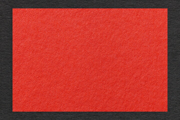 Texture of craft red color paper background with black border, macro. Structure of vintage dense...
