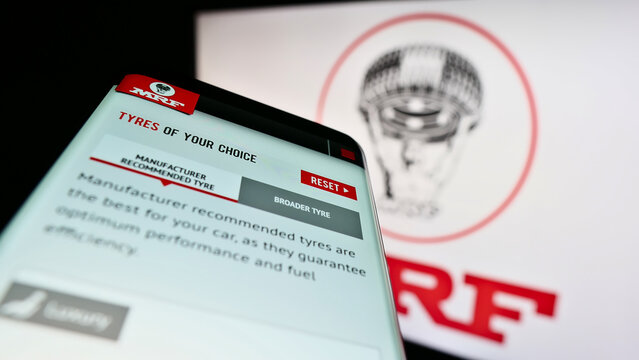 Stuttgart, Germany - 12-11-2022: Mobile phone with webpage of Indian company Madras Rubber Factory (MRF Tyres) on screen in front of logo. Focus on top-left of phone display.