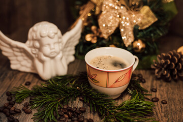 Obraz na płótnie Canvas Christmas composition angel, cup of coffee on a dark wooden table