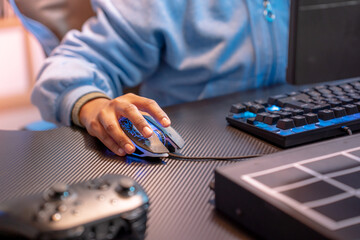 Closeup of unrecognizable hispanic woman hand clicking computer mouse game streaming online. High quality photo © deliris