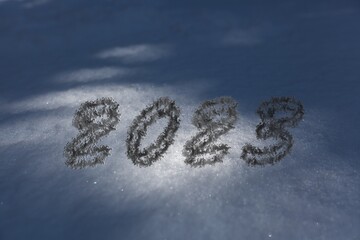 2023 numbers written in the white winter snow