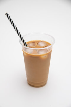 Isolated picture of ice coffee in a take away cup with ice cubes and straw