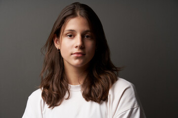 Closeup portrait of casual natural girl looking calm and confident