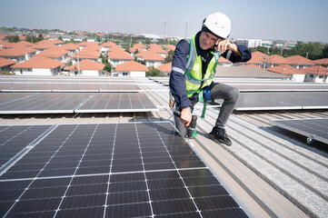 Tired Caucasian engineer man working with solar panel on roof factory