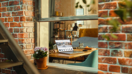 Laptop Computer with Online Shopping Website Display Standing on a Table in Stylish Living Room....