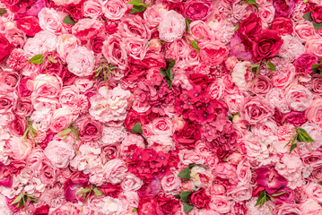Eine mit Rosenattrappen und anderen Plastkblumen dicht bestückte Wand