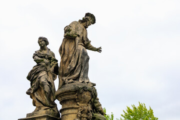 Ancient medieval sculptures on the Charles Bridge. Background with selective focus