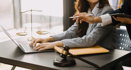 Male lawyer working with contract papers and wooden gavel on tabel in courtroom. justice and law ,attorney, court judge, concept.