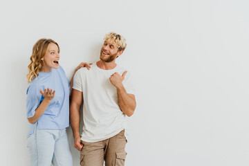 White blond excited couple laughing and gesturing together