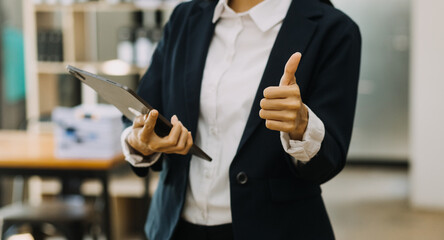 Businessman and team analyzing financial statement Finance task. with smart phone and laptop and...