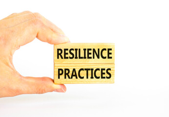 Resilience practices symbol. Concept word Resilience practices typed wooden blocks. Beautiful white table white background. Businessman hand. Business and resilience practices concept. Copy space.