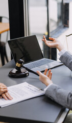 Male lawyer working with contract papers and wooden gavel on tabel in courtroom. justice and law ,attorney, court judge, concept.