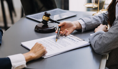 Male lawyer working with contract papers and wooden gavel on tabel in courtroom. justice and law ,attorney, court judge, concept.