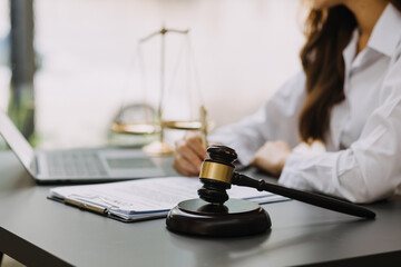 Male lawyer working with contract papers and wooden gavel on tabel in courtroom. justice and law ,attorney, court judge, concept.