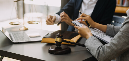 Male lawyer working with contract papers and wooden gavel on tabel in courtroom. justice and law ,attorney, court judge, concept.