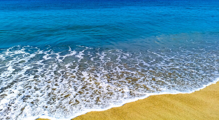 Beach sand blue water huge surfer waves Puerto Escondido Mexico.