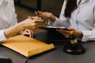 Male lawyer working with contract papers and wooden gavel on tabel in courtroom. justice and law ,attorney, court judge, concept.