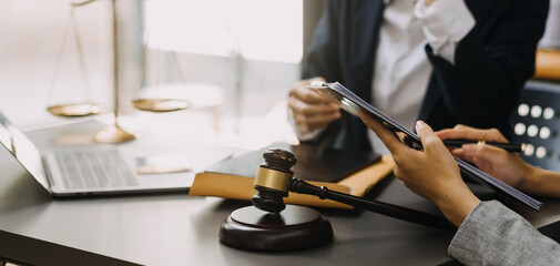 Male lawyer working with contract papers and wooden gavel on tabel in courtroom. justice and law ,attorney, court judge, concept.