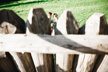 Beautiful romantic wedding couple of newlyweds hugging near old castle